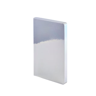 Das Covermaterial des Notizbuchs schimmert silberfarben und reflektiert die Farben der Umgebung.